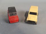 two toy cars sitting next to each other on a table