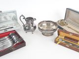 several silverware items including a teapot, spoons, and a box