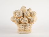 a white vase with a bunch of flowers in it