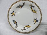 a white plate with blue and yellow designs on it