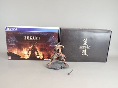 a close up of a figurine of a person holding a sword in front of a box