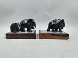 pair of black elephant bookends on wooden bases