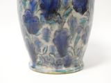 a blue and white vase sitting on a white surface