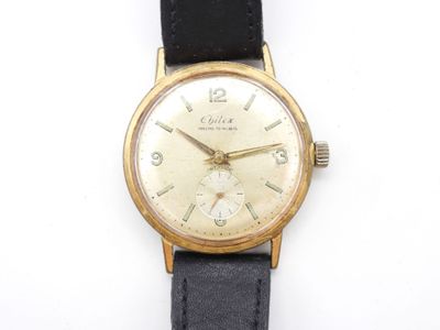an image of a close up of a wrist watch on a white surface