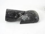 two pieces of black plastic that have been left on the ground