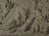 an old map of a mountain range with a red line on it