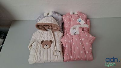 two baby sleeping bags on a table next to each other