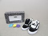a pair of black and white shoes next to a black and white purse