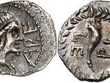 a silver coin with an image of a horse on it