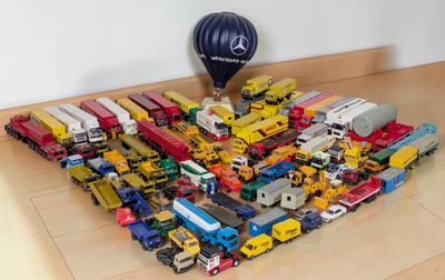 a lot of toy trucks and a hot air balloon on the floor