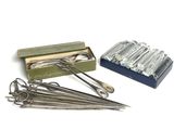 a box of needles and a pair of scissors on a table