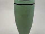 a green vase with a black stripe on it