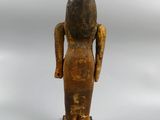 an image of a wooden statue of a woman standing on a wooden base