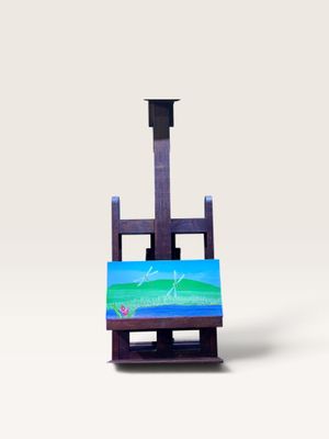 un chevalet d'artiste sur lequel repose un tableau, posé sur une surface blanche