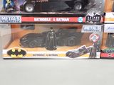 a box of batman and batmobile toys sitting on a table