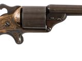 un gros plan d'un pistolet sur un fond blanc avec un fond blanc