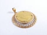 an image of a gold pendant with a coin in the center