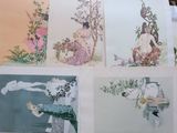 four cards with pictures of women and birds on them sitting on a table