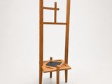 a wooden chair with a black seat on a white surface
