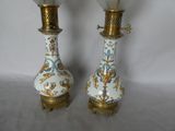 pair of porcelain lamps with gold and blue designs on them