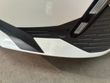 a close up of the front of a white car with black trims