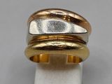 a close up of a ring with three different colors of gold and silver