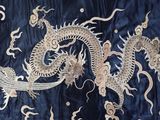 a dragon that is on a blue and gold cloth