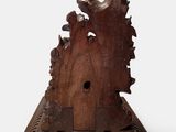 a wooden sculpture of a bird house on a white surface