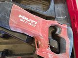 a red tool in a red case on the floor