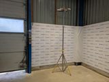 a camera on a tripod in front of a wall