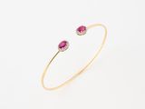 a yellow gold bracelet with a ruby stone and diamonds