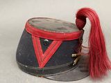 a hat with a red ribbon on top of it