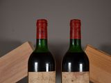 two bottles of wine sitting next to each other on a table
