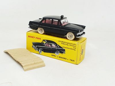 a black toy car sitting on top of a yellow box