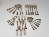 many forks and spoons laid out on the table