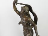 an image of a bronze statue of a woman holding a bird