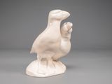 a white bird that is sitting on top of a table
