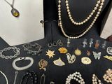 many different types of jewelry on display on a table