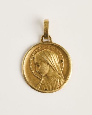 gros plan d'une médaille d'or sur une surface blanche