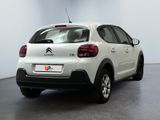 the rear of a white citrole parked in a room