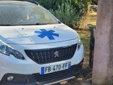 a white car with a blue star on it parked next to a white car