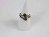 a close up of a ring on a white cone on a white surface