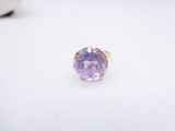 a close up of a purple ring on a white surface
