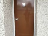 a red fire hydrant in front of a brown door