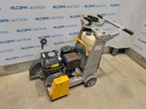 a close up of a machine on a concrete floor in front of a wall