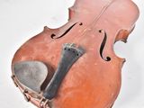 an old violin that is sitting on the ground