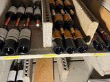 many bottles of wine sitting on a shelf in a room