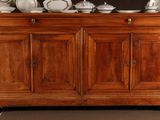 a large wooden cabinet with a lot of dishes on top of it