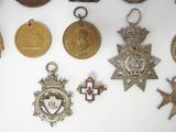 a lot of medals that are on a white surface