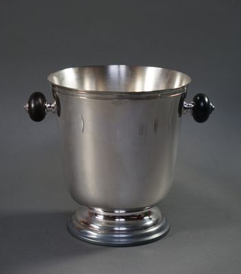 a silver ice bucket with two black balls in it